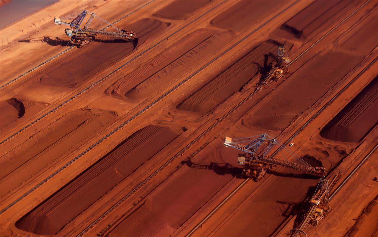 Iron Ore Outlook Cut by Australia as Global Supplies Surge